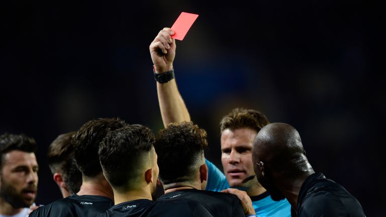 German referee Felix Brych shows red card to Porto's Brazilian defender Alex Telles during the UEFA Champions League round of 16 second leg football match 