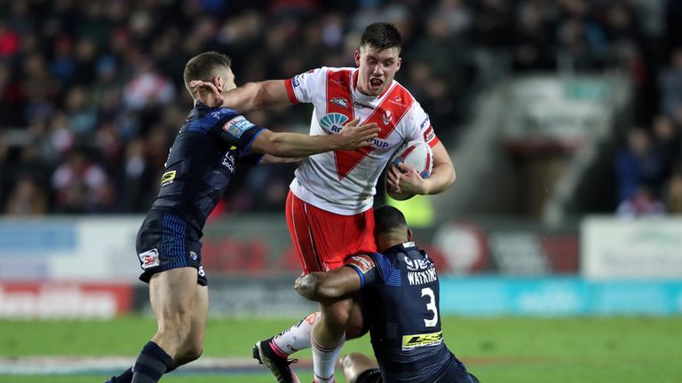St Helens' Joe Greenwood is tackled by Leeds' Kallum Watkins (right) and Matt Parcell during the Super League match at the Totally Wicked Stadium, St Helen