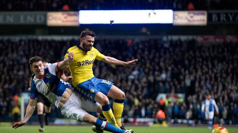 BLACKBURN, ENGLAND - FEBRUARY 1: Stuart Dallas of Leeds United is tackled by Darragh Lenihan of Blackburn Rovers during the Sky Bet Championship match betw