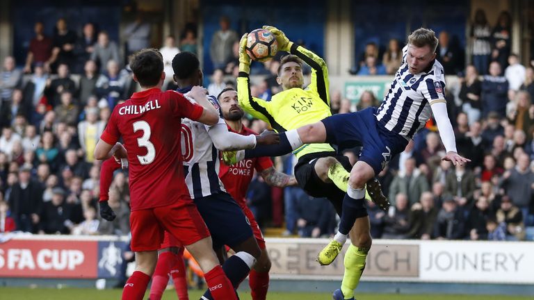 Leicester City's German goalkeeper Ron-Robert Zieler (2nd R) catches the ball under pressure from Millwall's Irish striker Aiden O'Brien (R) during the Eng
