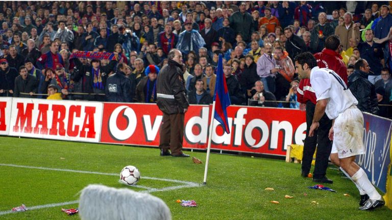 BARCELONA - NOVEMBER 23:  Luis Figo of Real Madrid is bombarded by missiles as he attempts to take a corner during the La Liga match between FC Barcelona a
