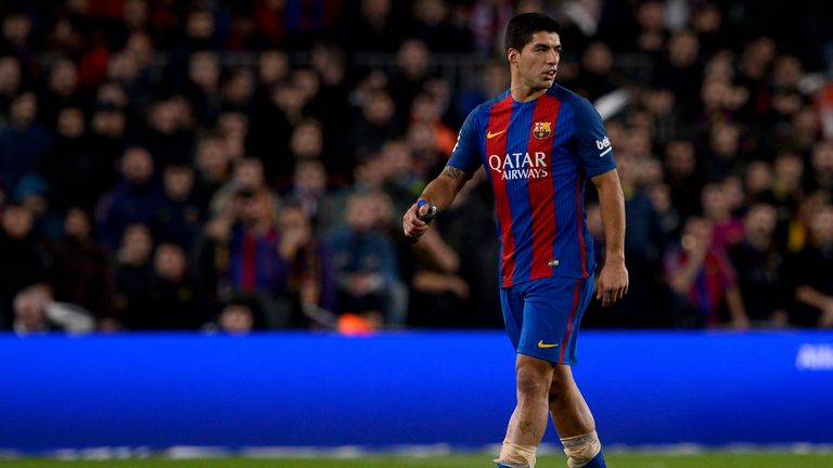 Barcelona's Uruguayan forward Luis Suarez (2ndL) leaves the pitch after receiving a red card during the Spanish Copa del Rey (King's Cup) semi final second