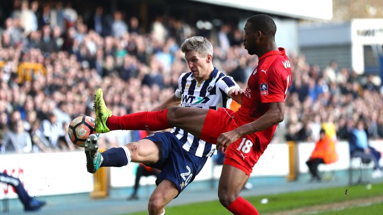 Steve Morison of Millwall (L) clears the ball while under pressure from Molla Wague of Leicester City (R) during the fifth round FA Cup match