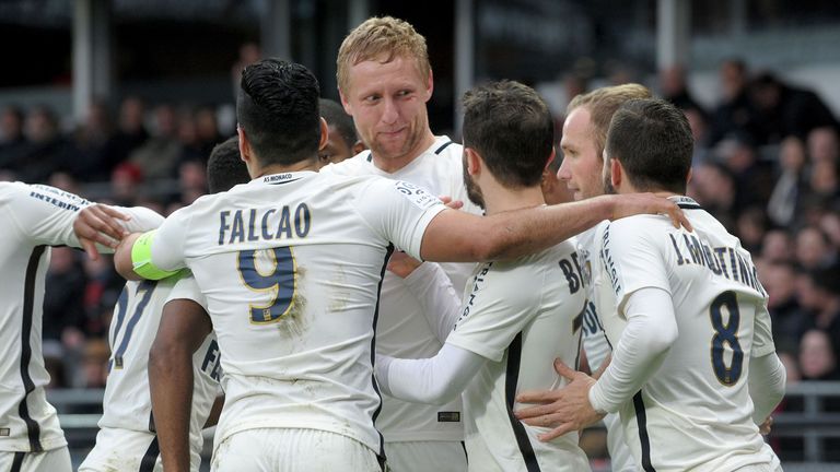 Monaco's Polish defender Kamil Glik (Rear C) is congratulated by his teammates after scoring  during the French L1 football match Guingamp (EAG) vs Monaco 