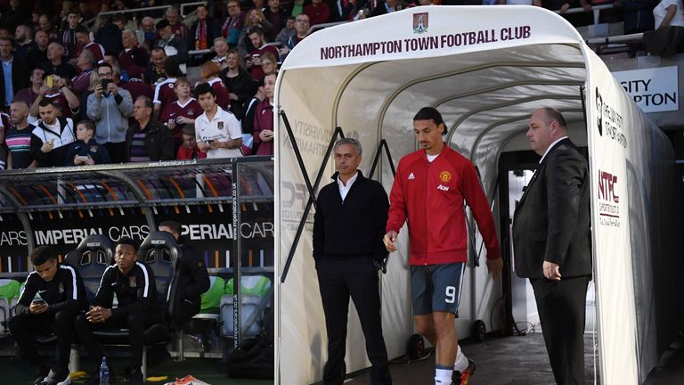 NORTHAMPTON, ENGLAND - SEPTEMBER 21: Jose Mourinho, Manager of Manchester United and Zlatan Ibrahimovic of Manchester United make their way out of the tunn
