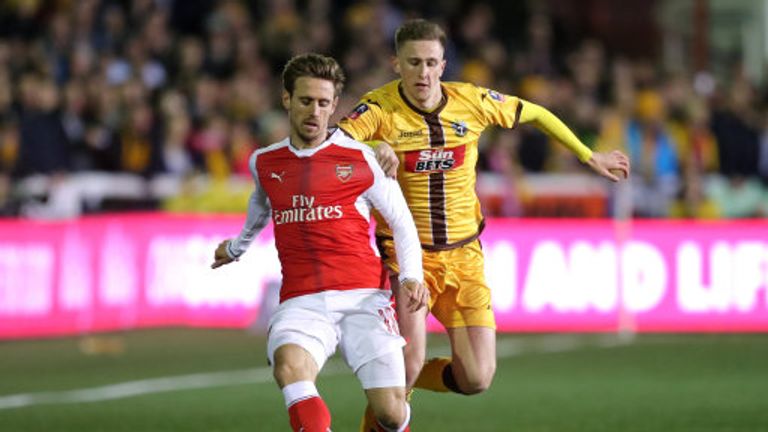 Arsenal's Nacho Monreal and Sutton's Adam May battle for the ball during the Emirates FA Cup, Fifth Round match at Gander Green Lane, London.