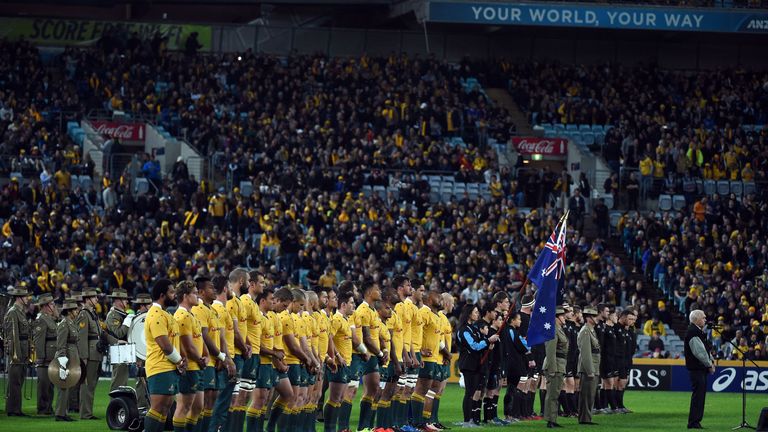 Australian  player (L) and New Zeland players line up for national anthems prior to their Bledisloe Cup Rugby Championship match in Sydney on 20/08/16