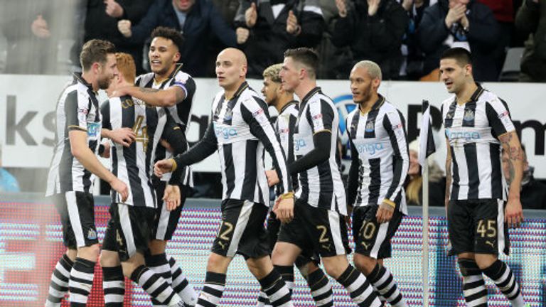 Newcastle players celebrate after an own goal by Aston Villa's Henri Lansbury put them 2-0 up at St. James' Park