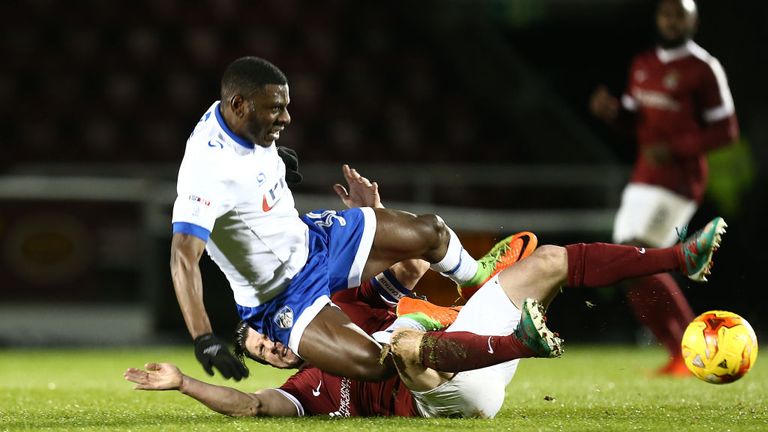 NORTHAMPTON, ENGLAND - FEBRUARY 28: David Buchanan of Northampton Town and Tope Obedayi of Oldham Athletic challenge for the ball during the Sky Bet League
