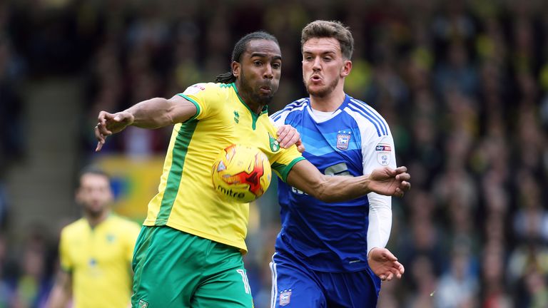 Cameron Jerome and Emyr Huws battle for possession at Carrow Road