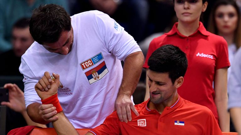 Serbia's Novak Djokovic receives medical treatment during the Davis Cup World Group first round singles tennis match between Serbia and Russia at Cair spor