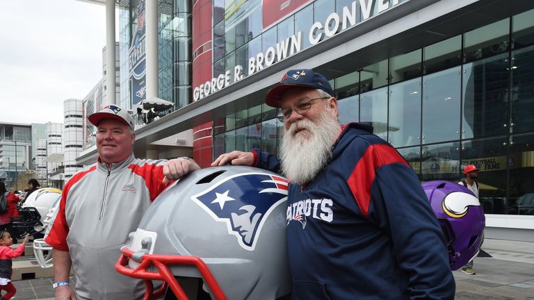 Patriots fans pose for a photo outside the NFL Experience in Houston