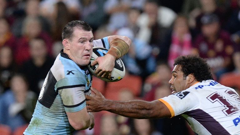 BRISBANE, AUSTRALIA - JUNE 27 2016: Paul Gallen of the Sharks gets past the defence of Sam Thaiday of the Broncos during the round 16 NRL match