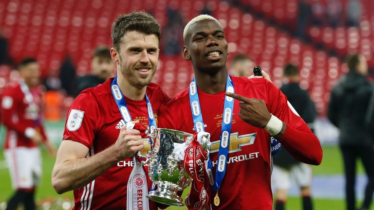 Paul Pogba and Michael Carrick celebrate with the EFL Cup