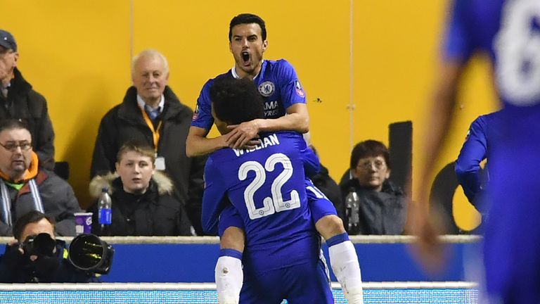 Chelsea's Spanish midfielder Pedro (up) celebrates with Chelsea's Brazilian midfielder Willian after scoring the opening goal of the English FA Cup fifth r