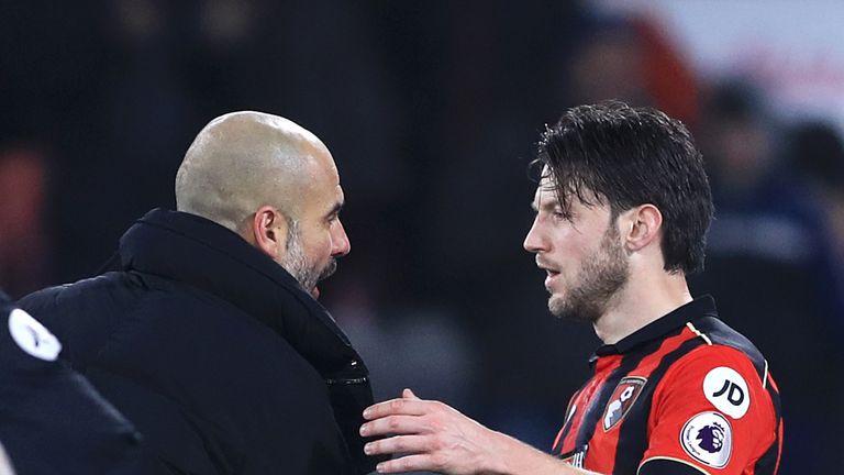 Manchester City manager Pep Guardiola (left) shakes hands and speaks to AFC Bournemouth's Harry Arter after the final whistle