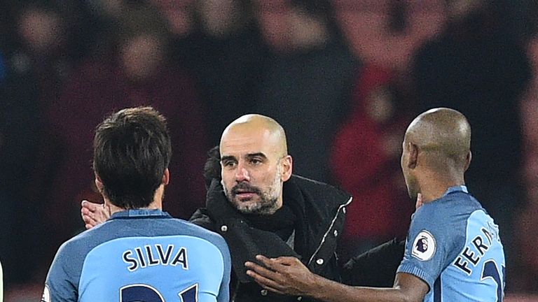 Manchester City's Spanish manager Pep Guardiola congratulates Manchester City's Spanish midfielder David Silva and Manchester City's Brazilian midfielder F