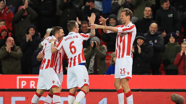 STOKE ON TRENT, ENGLAND - FEBRUARY 01:  Peter Crouch (R) of Stoke City celebrates scoring the opening goal with team mates during the Premier League match 