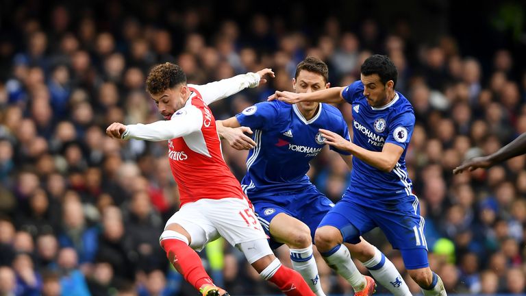 Alex Oxlade-Chamberlain looks to escape the attention of Nemanja Matic and Pedro in the first-half