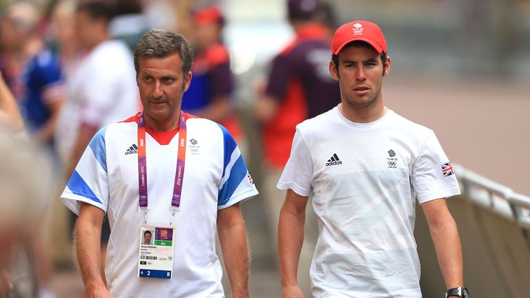 Great Britain's Mark Cavendish walks back from the mixed zone with doctor Richard Freeman after the mens Road Race at London 2012