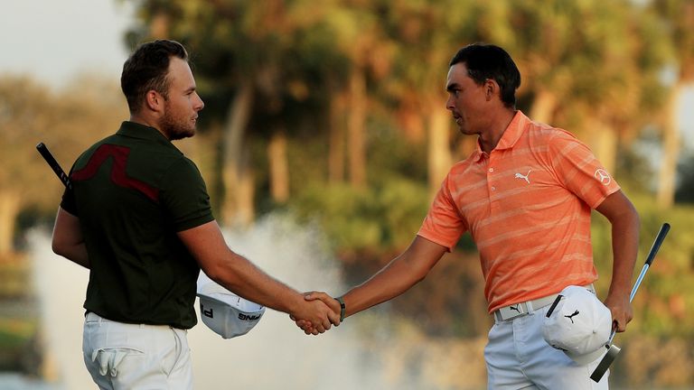 PALM BEACH GARDENS, FL - FEBRUARY 26:  Rickie Fowler (R) of the United States shakes hands with Tyrrell Hatton of England on the 18th green after Fowler wo