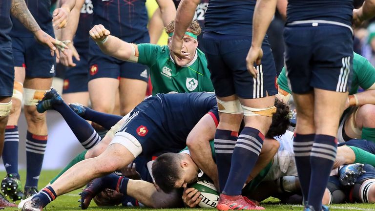 Conor Murray (C) pushes through the French defence to score a try