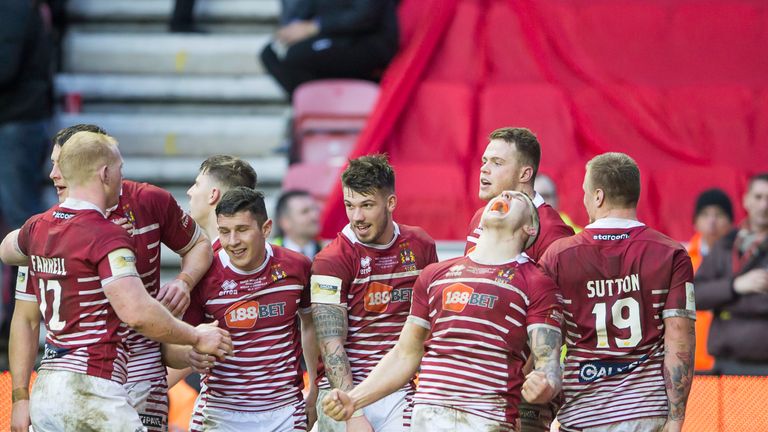 Sam Powell (second from right) is ecstatic as Wigan celebrate victory over Cronulla