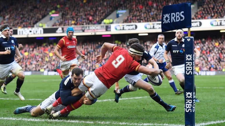 Rhys Webb is tackled into touch by Tim Visser of Scotland