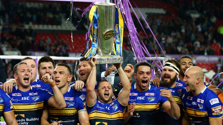 Rob Burrow of the Leeds Rhinos celebrates as he holds the trophy aloft with his team mates after the First Utility Super 