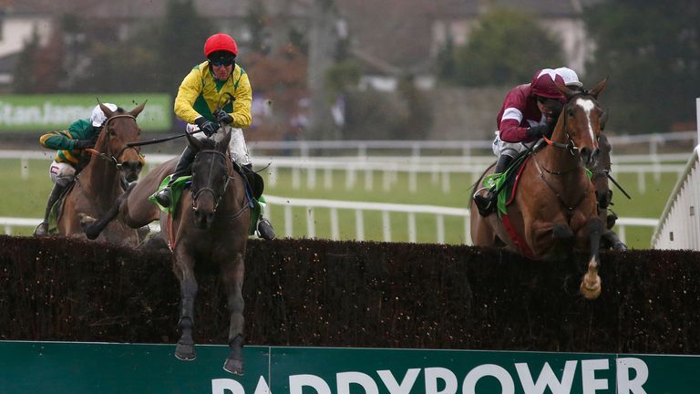 Robbie Power riding Sizing John (red cap) clear the last ahead of Don Poli in the Irish Gold Cup at Leopardstown