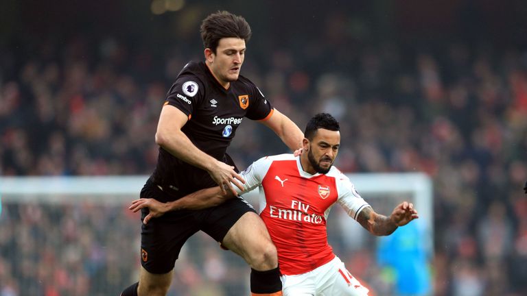 Theo Walcott tries to get away from Harry Maguire 