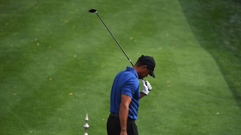DUBAI, UNITED ARAB EMIRATES - FEBRUARY 02:  Tiger Woods of the United States reacts as he tees off on the 1st hole during the first round of the Omega Duba