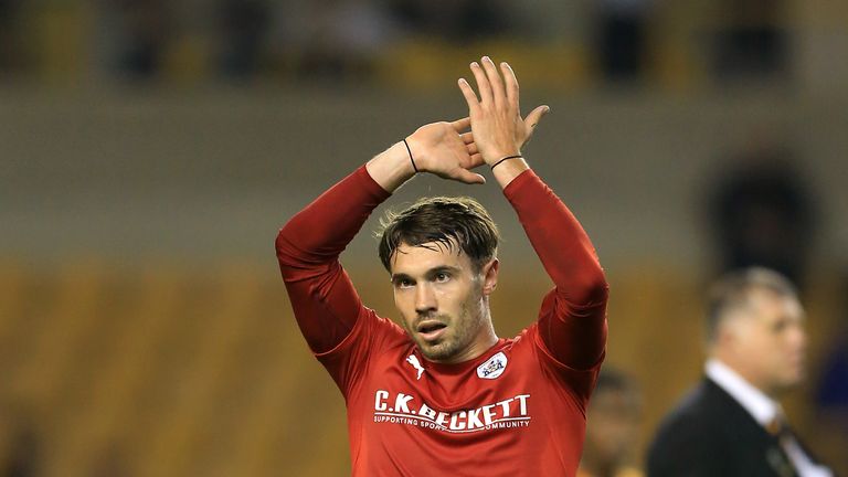 Barnsley's Tom Bradshaw applauds the travelling support