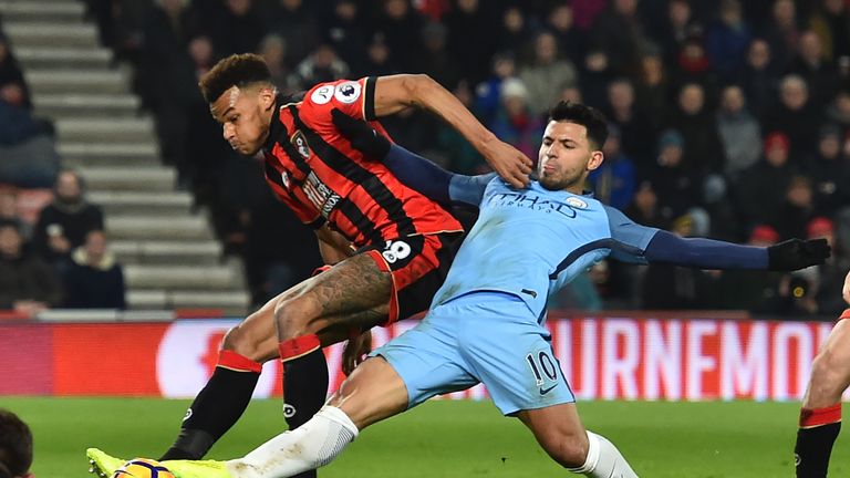 Manchester City's Argentinian striker Sergio Aguero (R) gets his foot to the ball ahead of Bournemouth's English defender Tyrone Mings to  score their seco