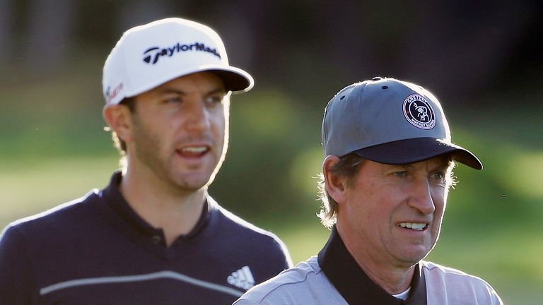 PEBBLE BEACH, CA - FEBRUARY 12:  Dustin Johnson (L) waits alongside hockey legend Wayne Gretzky during the first round of the AT&T Pebble Beach National Pr