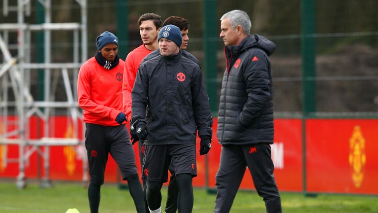 MANCHESTER, ENGLAND - FEBRUARY 21:  Jose Mourinho, manager of Manchester United walks past Wayne Rooney during a training session ahead of the UEFA Europa 
