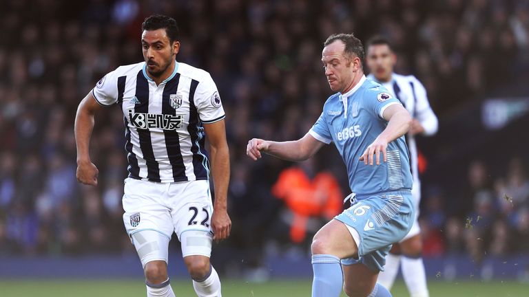 WEST BROMWICH, ENGLAND - FEBRUARY 04:  Nacer Chadli of West Bromwich Albion and Charlie Adam of Stoke City compete for the ball  during the Premier League 