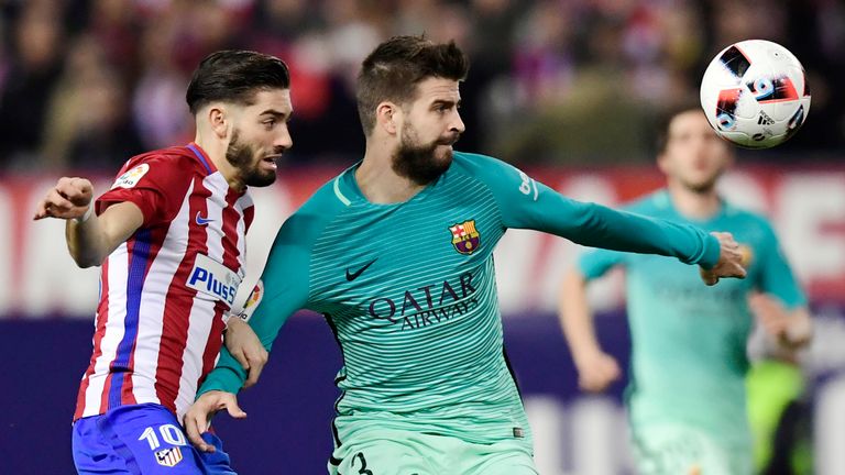 Yannick Ferreira Carrasco keeps track of Gerard Pique 