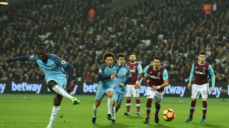 Manchester City's Ivorian midfielder Yaya Toure shoots to score his team's fourth goal from the penalty spot during the English Premier League football mat