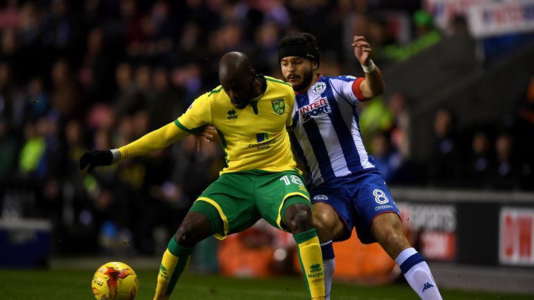 WIGAN, ENGLAND - FEBRUARY 07:  Youssouf Mulumbu of Norwich is tackled by Sam Morsy of Wigan during the Sky Bet Championship match between Wigan Athletic an