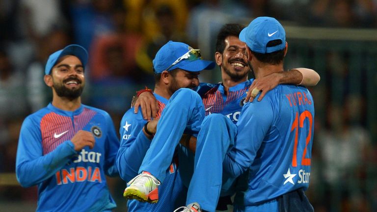 Indian bowler Yazvendra Chahal (2ndR) is lifted by his teammates for his six wicket haul against England during the third T20 cricket match between India a
