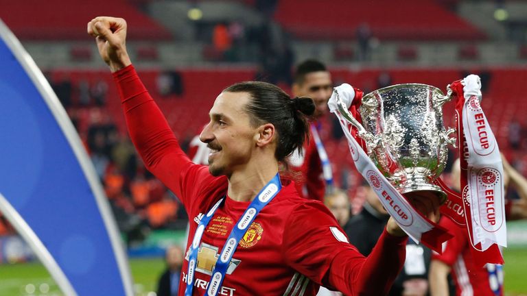 Manchester United's Swedish striker Zlatan Ibrahimovic celebrates with the trophy on the pitch after their victory in the English League Cup final football