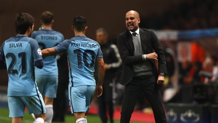 Manchester City manager Pep Guardiola gives instructions to David Silva and Sergio Aguero