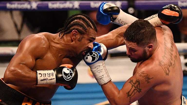 TOPSHOT - British boxers David Haye (L) and Tony Bellew (R) exchange blows during their heavyweight boxing match at the O2 arena in London on March 4, 2017