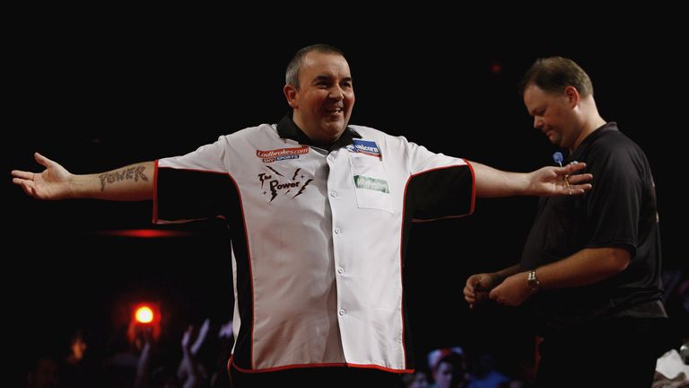 PURFLEET, UNITED KINGDOM - JANUARY 01:  Phil Taylor of England celebrates a point against Raymond Van Barneveld of Holland Britain during the finals of the