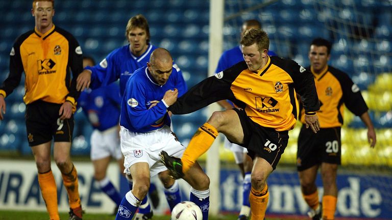 LONDON - JANUARY 14 2003:  Robbie Ryan of Millwall tackles Tom Youngs of Cambridge Utd during an FA Cup third round replay