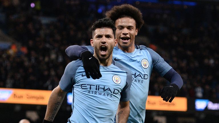 Manchester City's Argentinian striker Sergio Aguero (L) celebrates scoring his team's second goal during the FA Cup fourth round replay football match betw