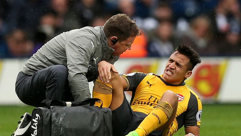 Alexis Sanchez receives treatment after injuring his ankle at The Hawthorns