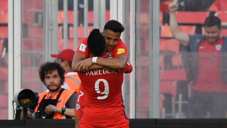 Chile's Esteban Paredes (bottom) celebrates with teammate forward Alexis Sanchez  after scoring against Venezuela during their 2018 FIFA World Cup qualifie