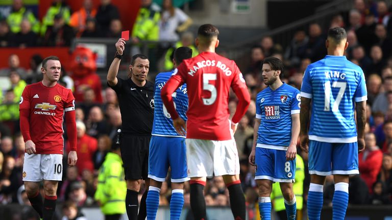 MANCHESTER, ENGLAND - MARCH 04:  Andrew Surman of AFC Bournemouth (C) is shown a red card by referee Kevin Friend (L) during the Premier League match betwe